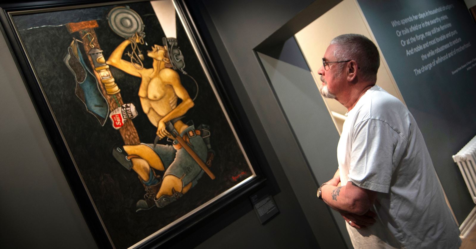 man looking at artwork inside Mining Art Gallery
